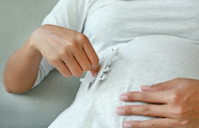 Mujer en la semana 36 del embarazo a punto de viajar en avión