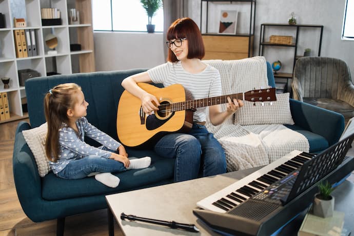 mujer enseñando música a niña