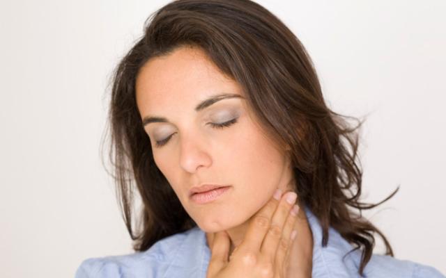 mujer tocandose cuello por afonia